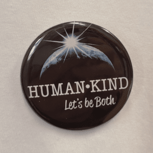 Human Kind button on white shirt